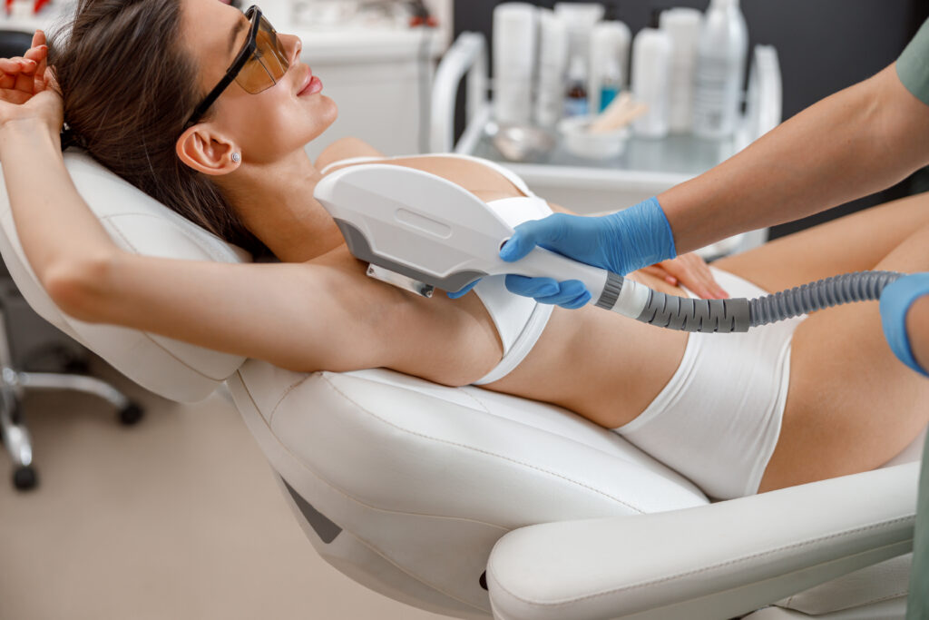Armpit hair laser removal procedure with ipl machine in a beauty salon